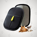 Pet travel carrier with a cat and dog in front of it on a light gray background with paw prints.